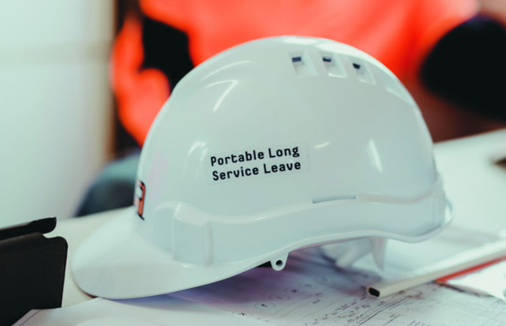 Hard hat on a table - the side reads 'Portable Long Service Leave