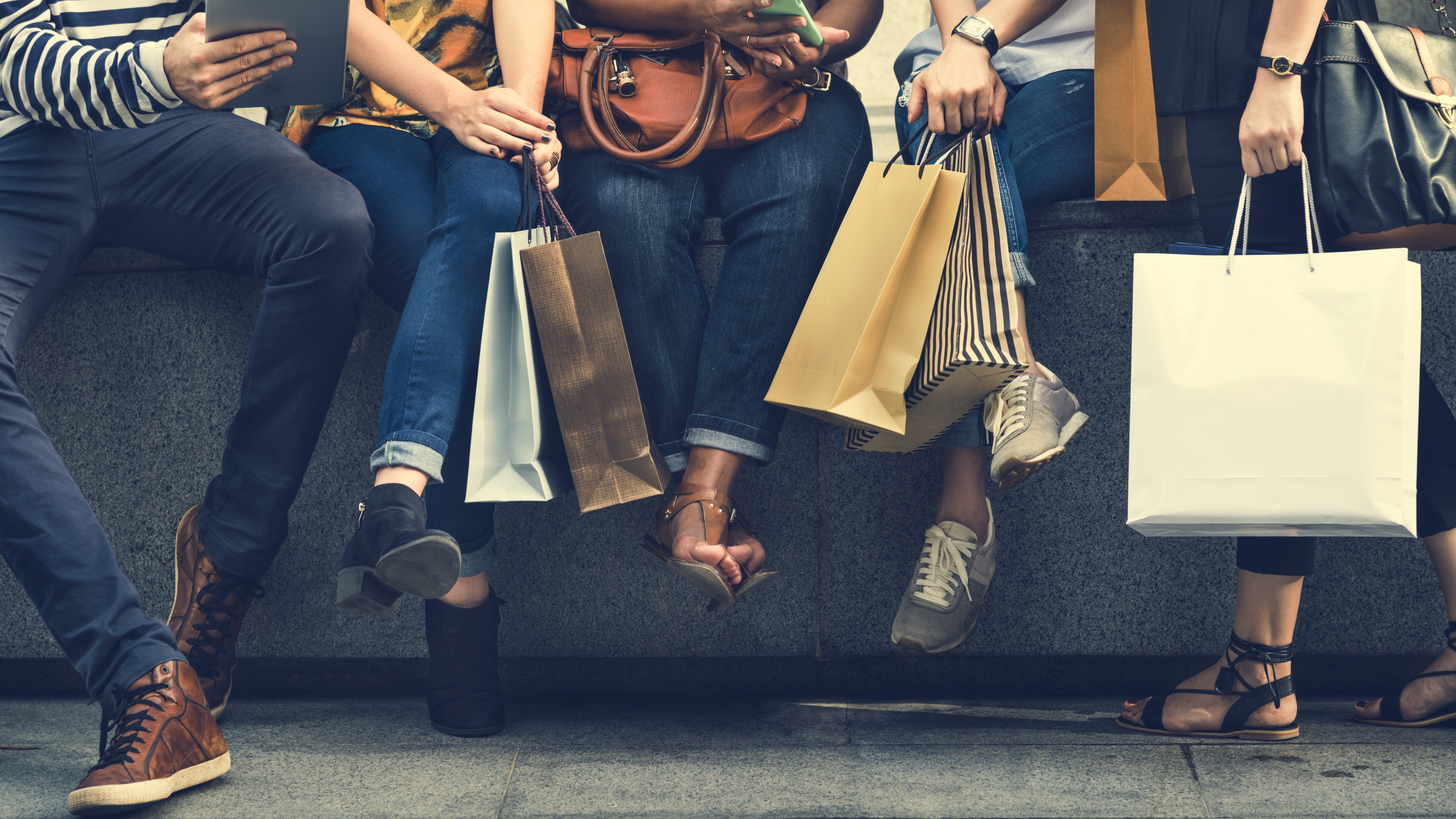 Row of shoppers with shopping bags