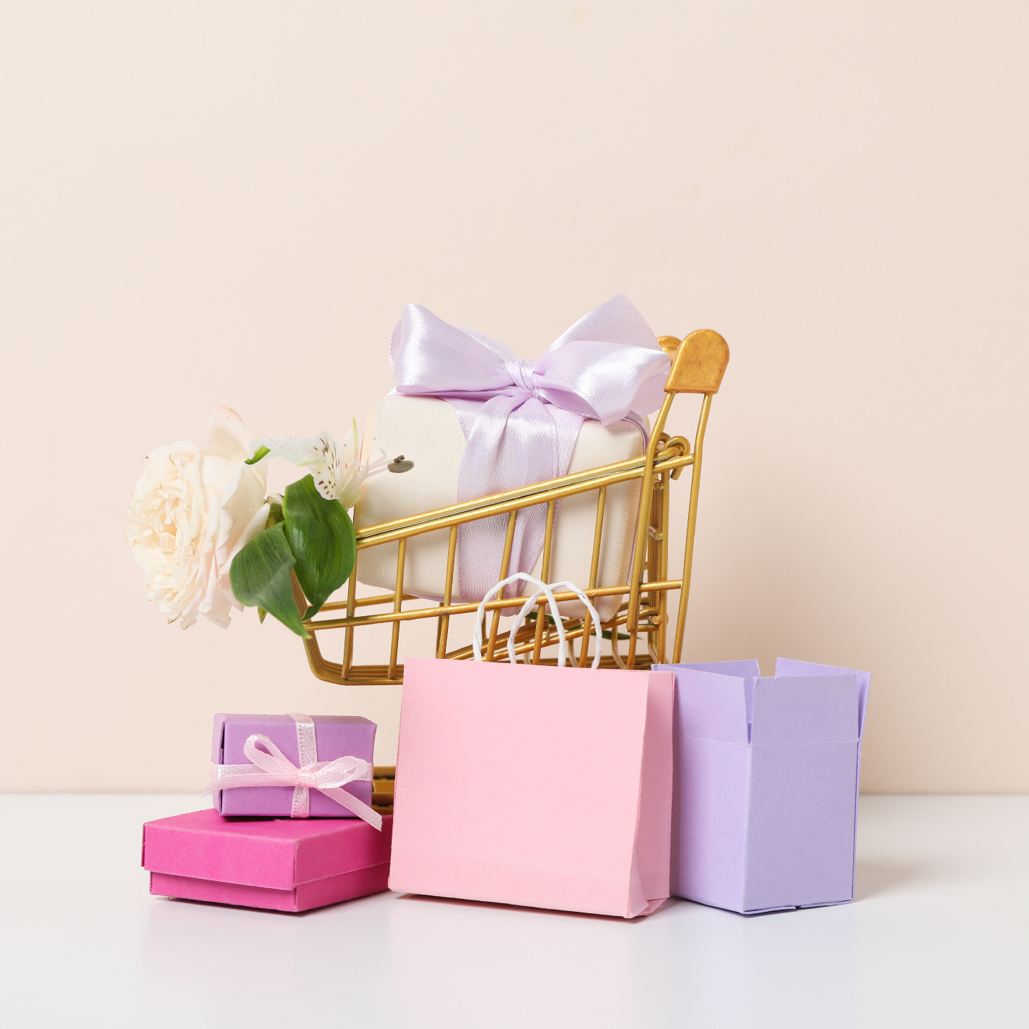 Image of a gold shopping trolley filled with wrapped gifts in pink and purple paper and bows.