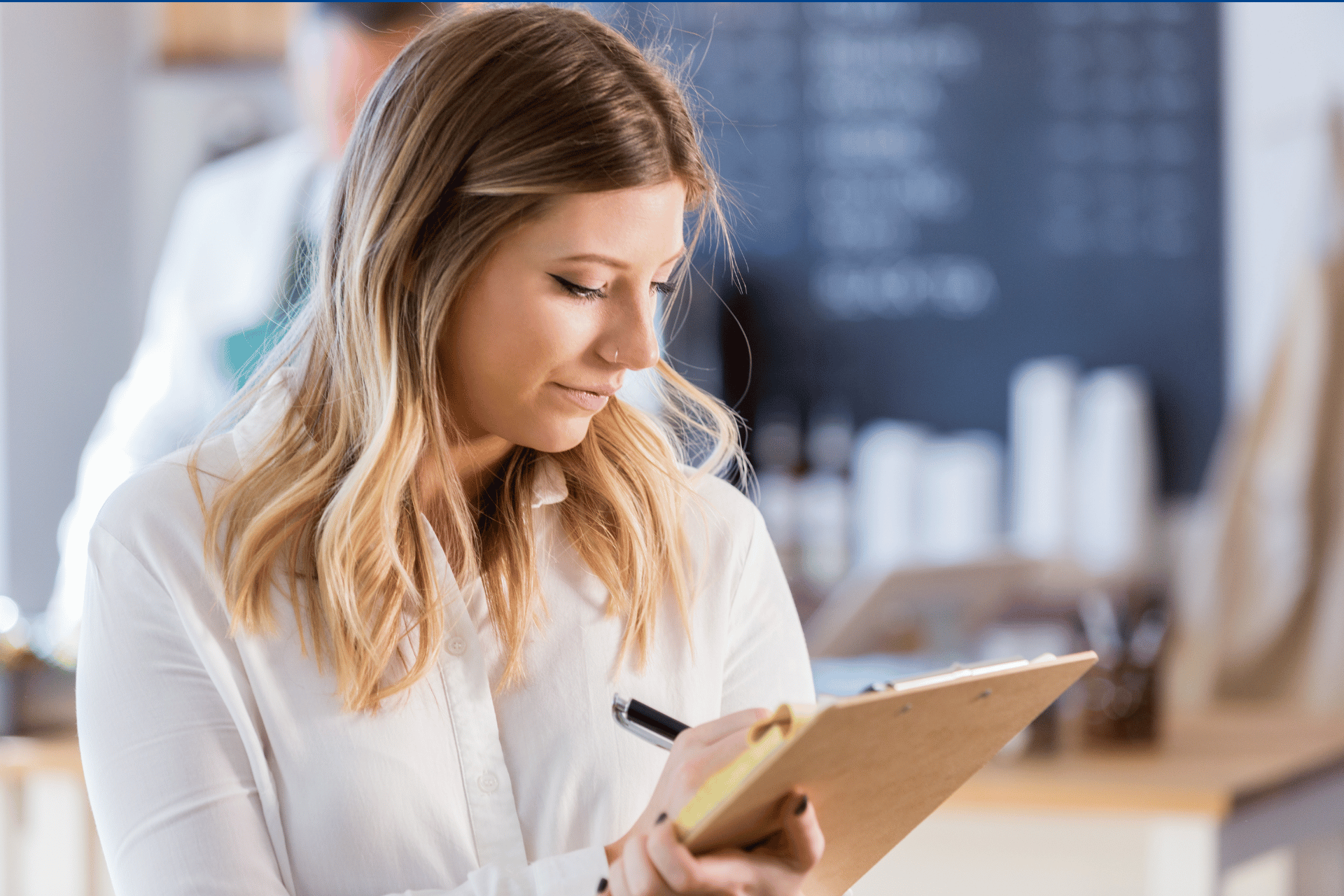 Image of woman inspecting workplace with clipboard